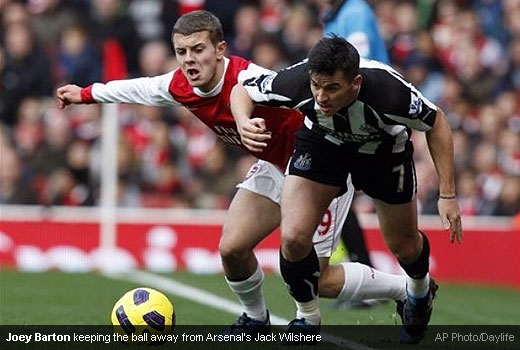 Joey Barton keeping the ball away from Arsenal’s Jack Wilshere