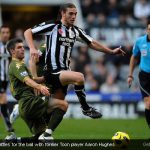 Andy Carroll battles for the ball with former Toon player Aaron Hughes Andy Carroll battles for the ball with former Toon player Aaron Hughes