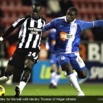 Cheik Tiote battles for the ball with Hendry Thomas of Wigan Athletic Cheik Tiote battles for the ball with Hendry Thomas of Wigan Athletic