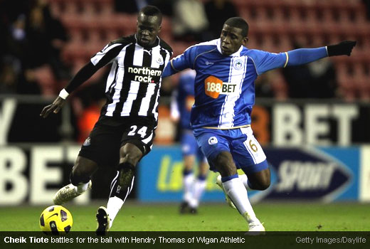 Cheik Tiote battles for the ball with Hendry Thomas of Wigan Athletic