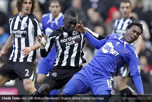 Cheik Tiote vies with Bolton Wanderers' English striker Daniel Sturridge