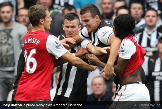 Joey Barton is pulled away from Arsenal's Gervinho [Magpies Zone/AP Photo/DayLife]