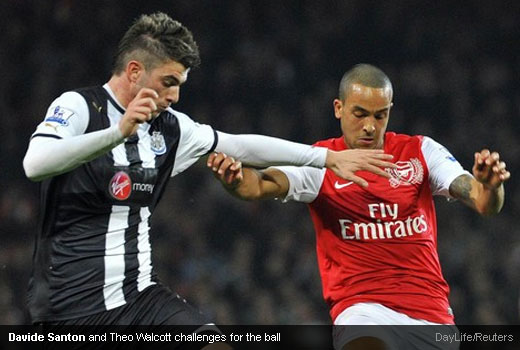 Davide Santon and Theo Walcott challenges for the ball
