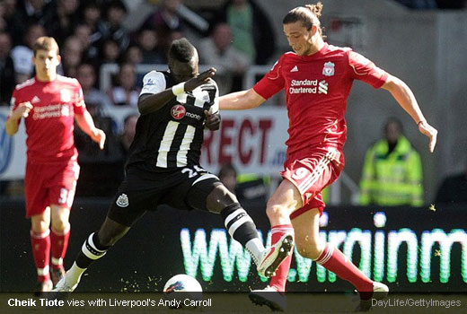 Cheik Tiote vies with Liverpool's Andy Carroll