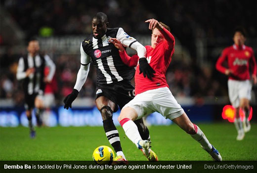 Demba Ba is tackled by Phil Jones during the game against Manchester United
