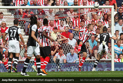 Joey Barton sees his headed effort stopped by Seb Larrson's